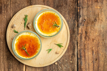 two delicious cream brulee or brule, traditional french vanilla cream dessert with caramelised sugar, place for text, top view