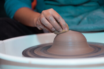 Pottery artist, Young female making a piece of clay molding calmly and meticulously In order to produce the most attractive work possible,