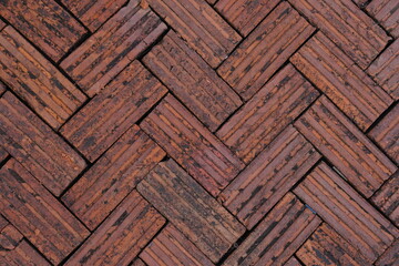 Walkway is paved with brown bricks