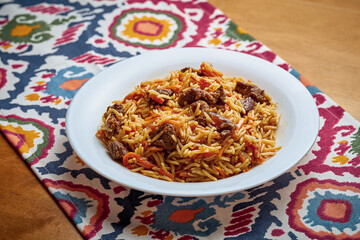 Classic oriental pilaf with meat and spices served on a plate