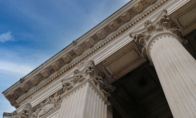 Classic architectural column. Details of architecture of historical construction. Element of exterior building with columns and Stucco molding on ceiling of architectural structure in London, UK.