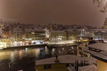 Foto op Plexiglas Aerial view of the old town of City of Zürich on a late autumn night with snowfall and Great Minster church in the background. Photo taken December 10th, 2022, Zurich, Switzerland. © Michael Derrer Fuchs