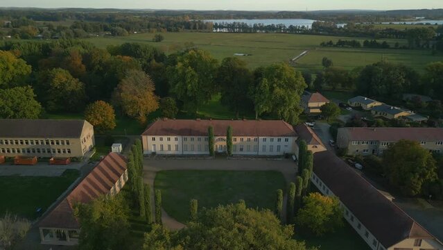 classicist chateau in brandenburg. Smooth aerial view flight fly reverse drone
Paretz castle havelland Germany at summer evening 2022. High Quality 4k Cinematic footage