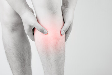 Fototapeta premium Shin injury. Male hand holding front leg with shin pain. Concept of health care, exercise-induced muscle soreness, injured leg bone