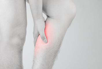 Male hand holding calf pain area. concept of health care.  inflammatory muscle disease, calf muscle...