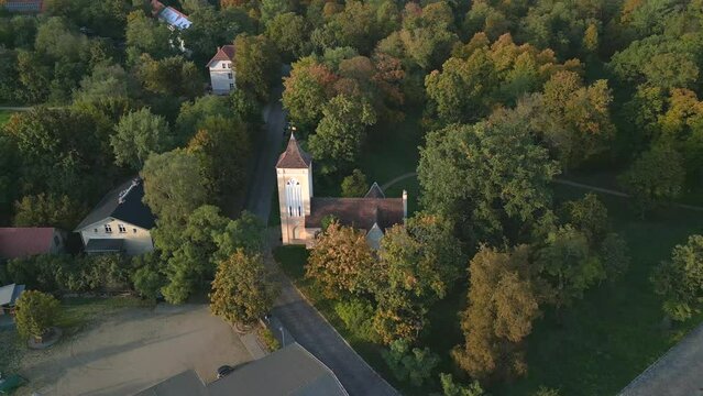 Golden hour. Magic aerial view flight panorama orbit drone
Village church Paretz Brandenburg Havelland Germany summer evening 2022. High Quality 4k Cinematic footage