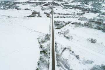 drone aerial view of a road in a snow-covered landscape