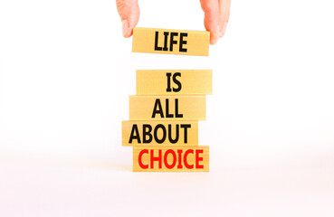 Choice and life symbol. Concept words Life is all about choice on wooden blocks. Beautiful white table white background. Businessman hand. Business choice and life concept. Copy space.