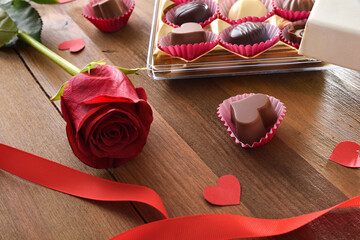 Romantic background box of chocolates on rustic table elevated view
