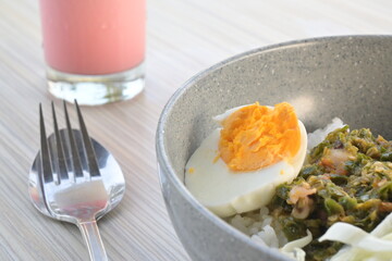 boiled eggs in a plate on a wooden table (natural light)