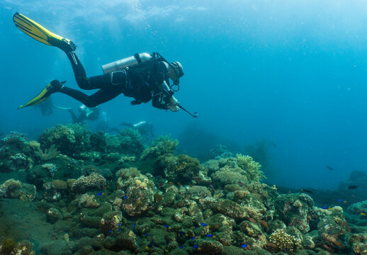 Scuba diver filming with compact video camera around Komodo Island in Indonesia