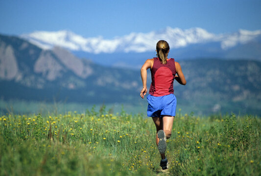 A woman trail running near Boulder, CO.