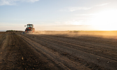 Fototapeta premium Farmer preparing his field in a tractor