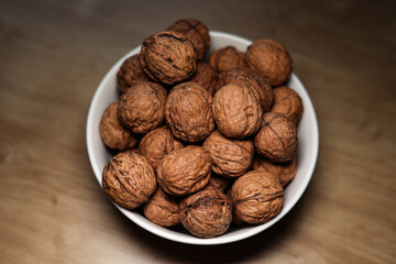 Walnuts, snack. Some walnuts in a bowl on the table in the kitchen. 