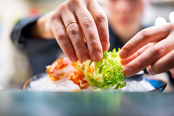 chef decorated plate with food on kitchen