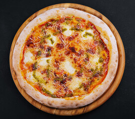 Baked vegetarian crusty pizza with mozzarella and pesto sauce
