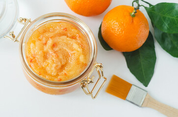 Orange clementine fruit mask (scrub) in a glass jar. Homemade face or body mask, natural beauty...