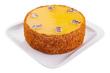 Carrot cake in yellow glaze on plate