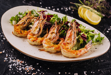 Mixed salad with tiger prawns on plate