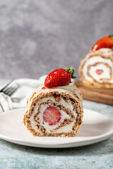 Strawberry Roll Cake. Log cake with cream and strawberries on a stone background. close up