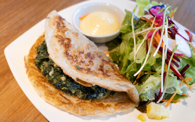 Spinach roti and vegetable salad on a plate