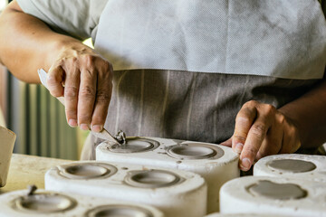 Potter working in her art studio.