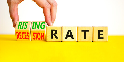 Recession or rising rate symbol. Concept word Recession rate Rising rate on wooden cubes. Businessman hand. Beautiful yellow table white background. Business recession rising rate concept. Copy space.