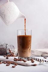Morning ice coffee with milk or latter in glass and milk jug