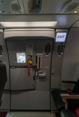 Exit sign in passenger airplane. Emergency exit sign on airplane. Exit airplane sign	