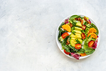 Bowl full of healthy vegetarian salad with avocado and tomatoes