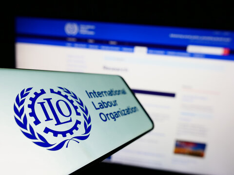 Stuttgart, Germany - 01-15-2023: Smartphone with logo of UN agency International Labour Organization (ILO) on screen in front of website. Focus on left of phone display.