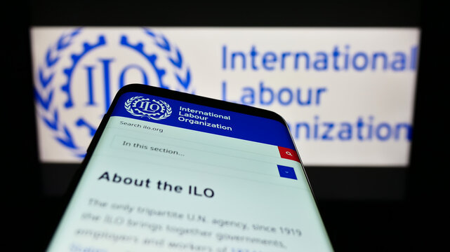 Stuttgart, Germany - 01-15-2023: Mobile phone with website of UN agency International Labour Organization (ILO) on screen in front of logo. Focus on top-left of phone display.