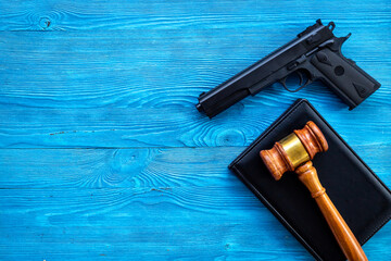 Hand gun weapon and judges gavel - gun law. Illegal use of weapons concept