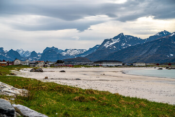 Obraz premium Photograph of Rambergstranda beach in Lofoten, Norway, during spring on a clear day with clouds