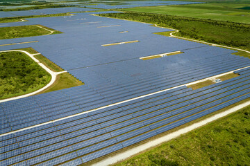 Aerial view of big sustainable electric power plant with many rows of solar photovoltaic panels for producing clean electrical energy. Renewable electricity with zero emission concept