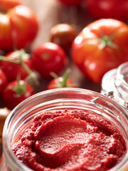 Tomatoes and tomato paste on table