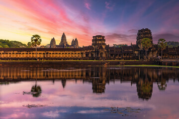 Angkor Wat temple reflecting in water of Lotus pond at sunset