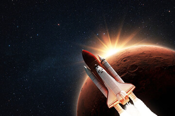 New space shuttle rocket successfully flies to the red planet Mars at sunset in starry space....