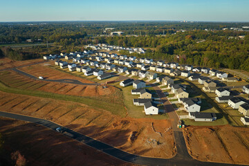 Aerial view of real estate development with tightly located family houses under construction in...