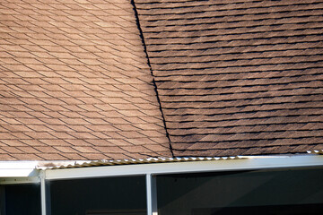 Closeup of house roof top covered with asphalt or bitumen shingles. Waterproofing of new building