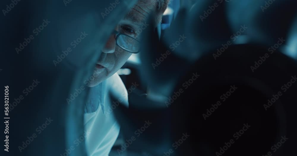 Aufkleber Close Up Portrait of a Middle Age Engineer in Glasses Examining a Rotating Fan on a High Tech Jet Engine. Research and Development Process of an Advanced Jet Engine in a Technology Startup