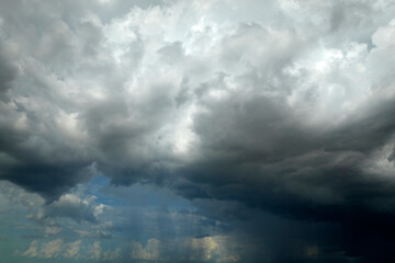 Landscape of dark ominous clouds forming on stormy sky during heavy thunderstorm