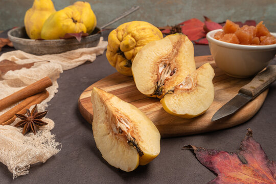 Quince fruit and bowl with quince cheese or marmelada is a sweet, thick jelly made of the pulp of the quince fruit. Dulce de membrillo in Spain