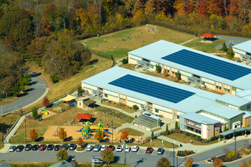Roof of american school building covered with photovoltaic solar panels for production of electric...
