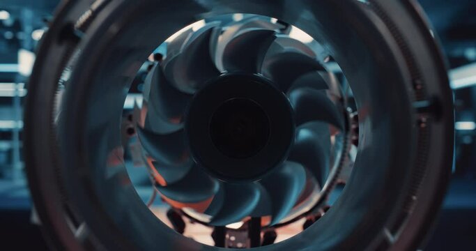 Adult Engineer in a White Scientist Coat with Laptop Computer Comes Up to Perform Diagnostics and Tests on a Futuristic Aerospace Jet Engine. Zoom Out Footage From Inside an Advanced Turbine