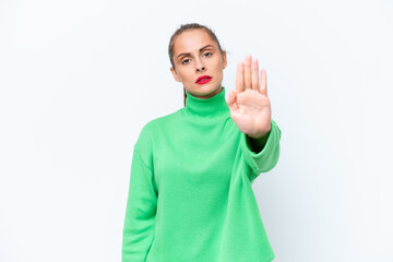 Young caucasian woman isolated on white background making stop gesture