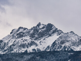 Mount Pilatus, snow-covered mountain in the Swiss Alps on a cloudy day