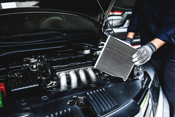 Car air conditioner system maintenance, Hand mechanic holding car air filter to check for clean dirty or fix repair heat have a problem or replace new or change filter. - obrazy, fototapety, plakaty