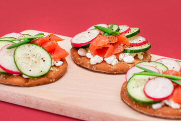 Crispy Cracker Sandwiches with Fresh Salmon, Cucumber, Radish, Cottage Cheese and Green Onions. Easy Breakfast. Quick and Healthy Sandwiches. Crispbread with Tasty Filling. Healthy Dietary Snack