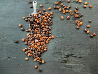 Blended roasted coffee beans or mixed coffee beans on a black background.